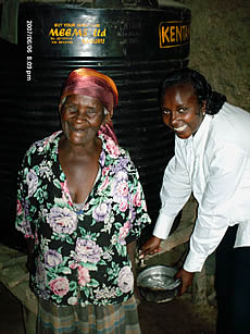 Monicah with water tank recipient